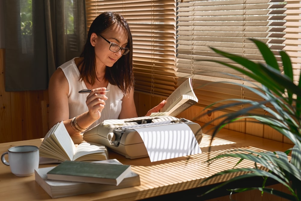 female writer in glasses