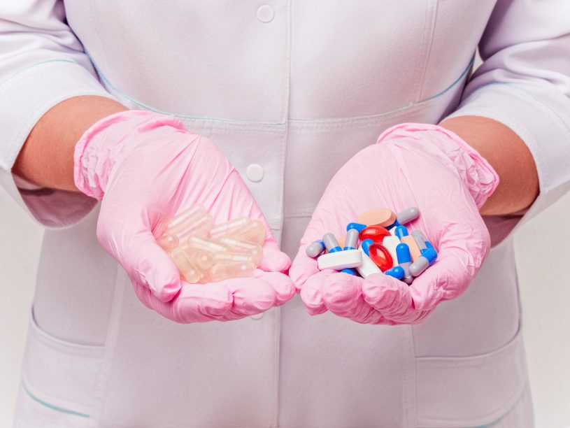 Doctor is holding different capsules