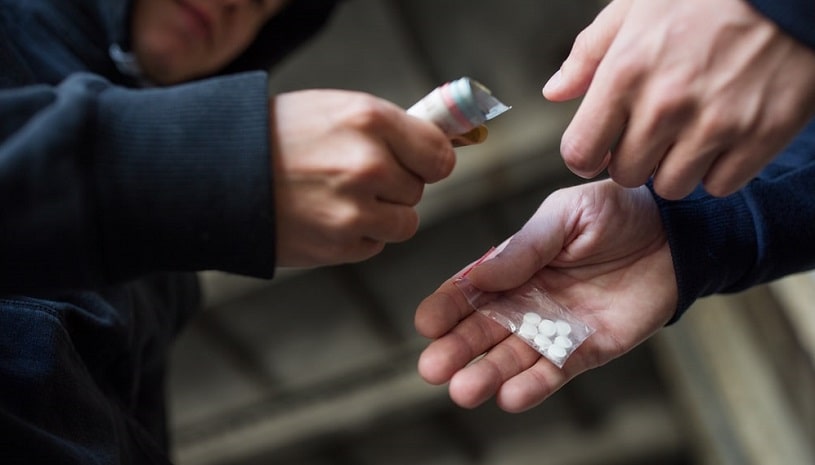 Man buying Baclofen pills on the street illegally.