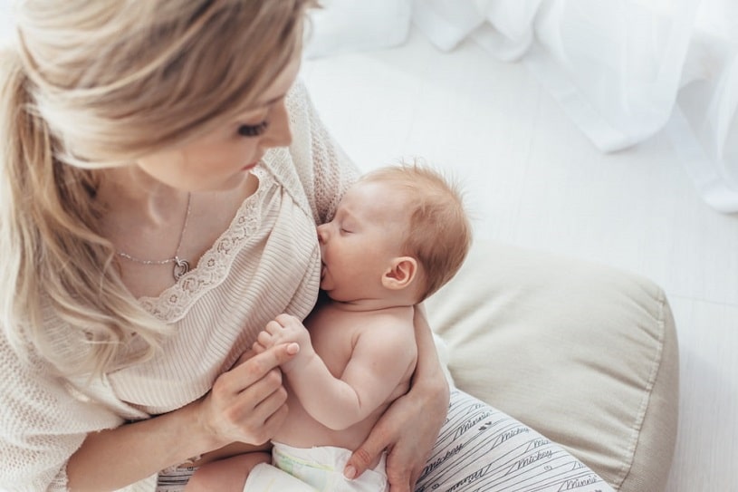 Breastfeeding mother holding her baby.