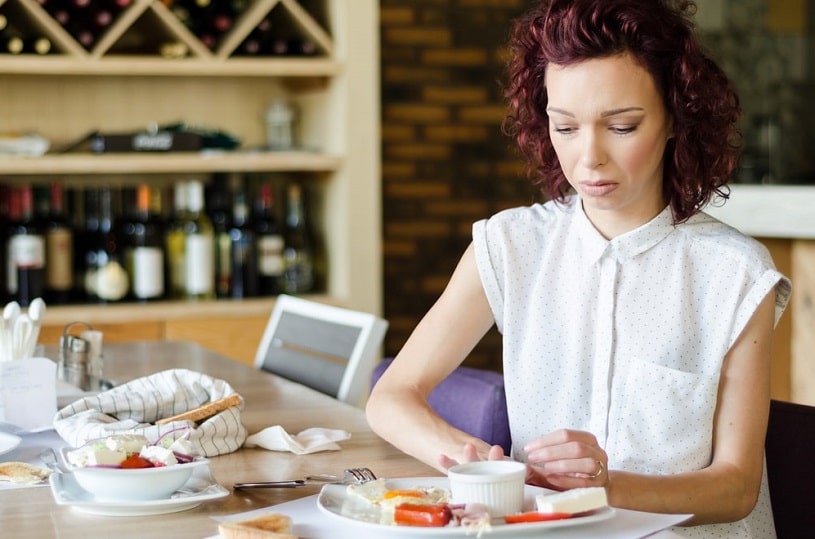Skinny woman refuses food due to reduced appetite.