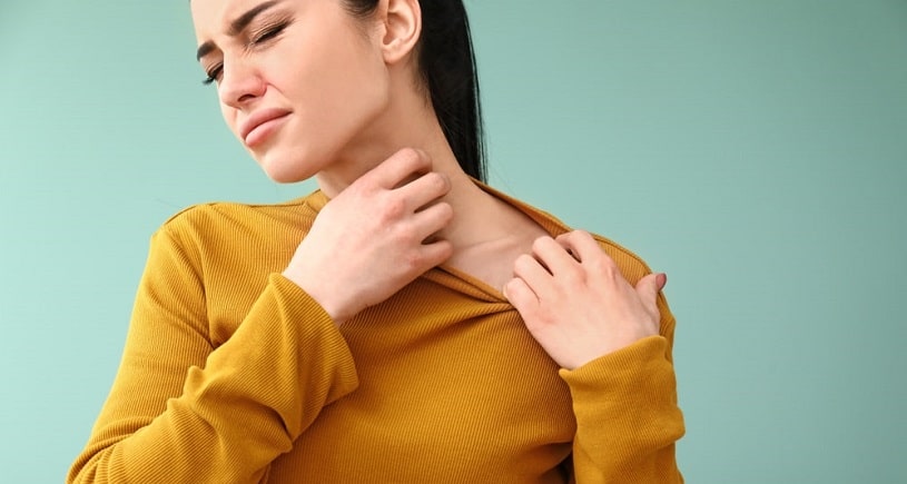 Woman experiencing dilaudid allergy, scratching her neck.