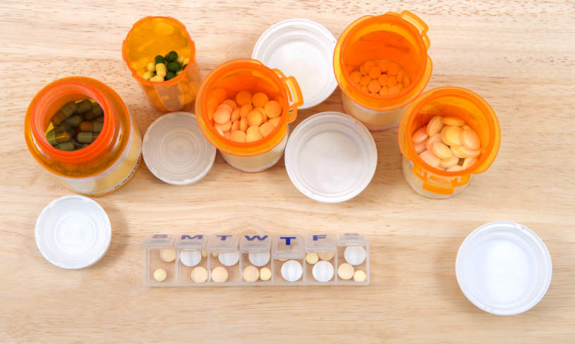 Different pills and capsules on the table.