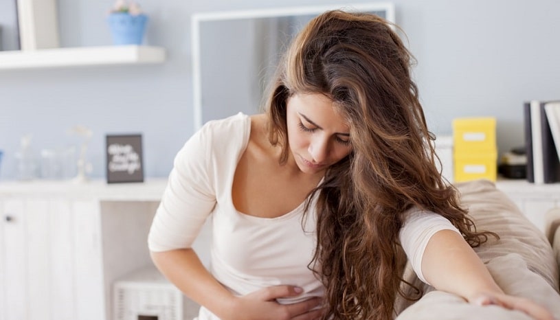 Woman experiencing nausea after Kratom use.