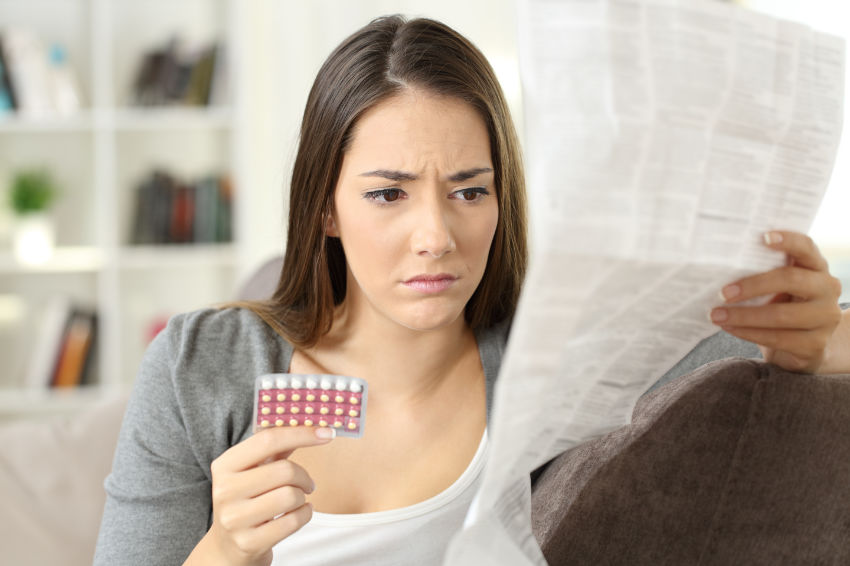 A woman reads a list of Lexapro's side effects.