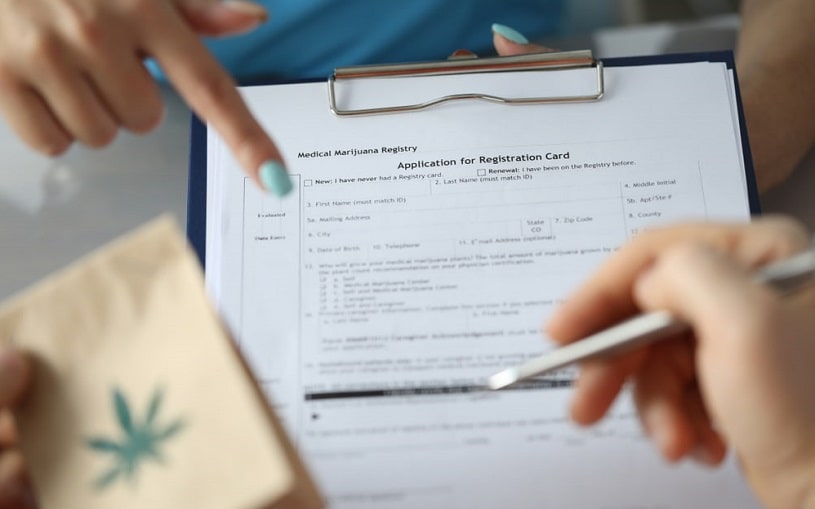 Woman pointing at medical marijuana card.
