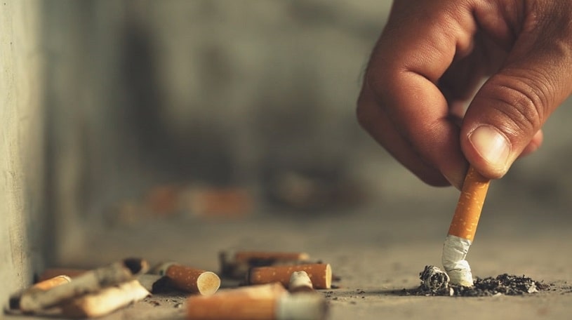 Hand putting out a cigarette.
