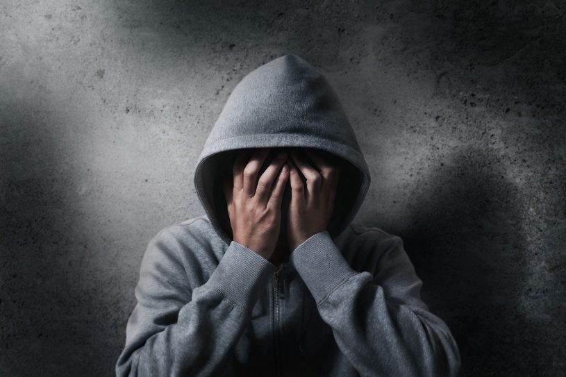 Man in the hood covers his face.