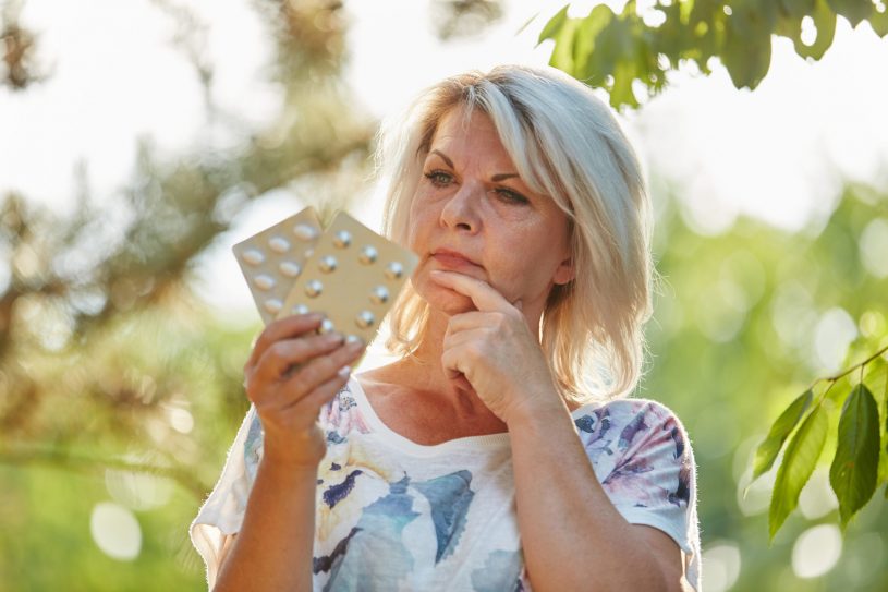 Elderly Woman is Checking 2 Medicines