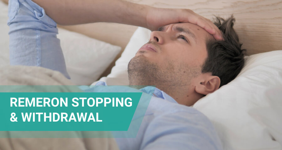 Man lying in bed with his hand on his forehead, illustrating Remeron withdrawal symptoms and the challenges of stopping mirtazapine.