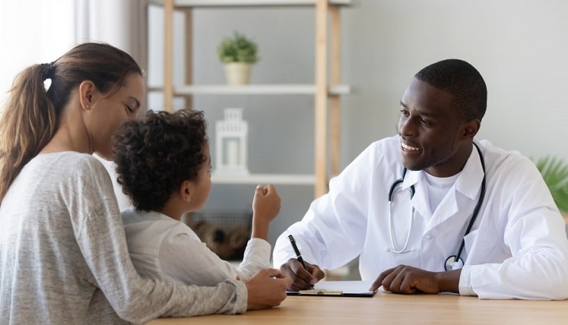 Doctor talking to a mother and child.