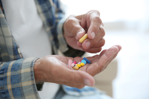 Senior man taking other pills with Benadryl