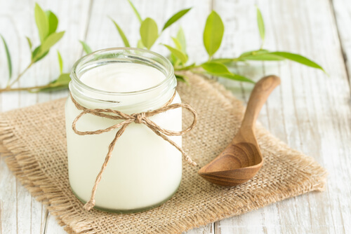 Yogurt in glass bottles on wooden table