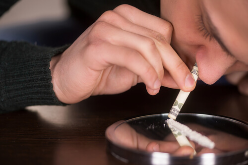 man is snorting painkillers