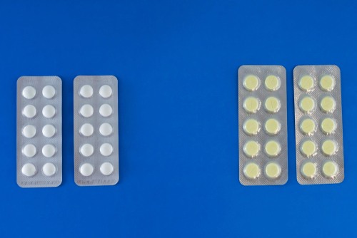 Two blisters of barbs and benzos on blue background