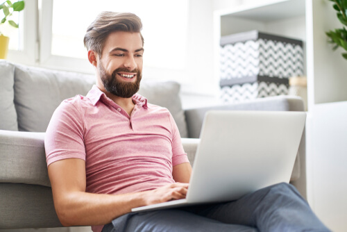 man using laptop to connect with NA online.
