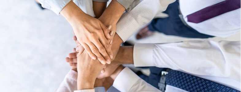 Team joining hands in support