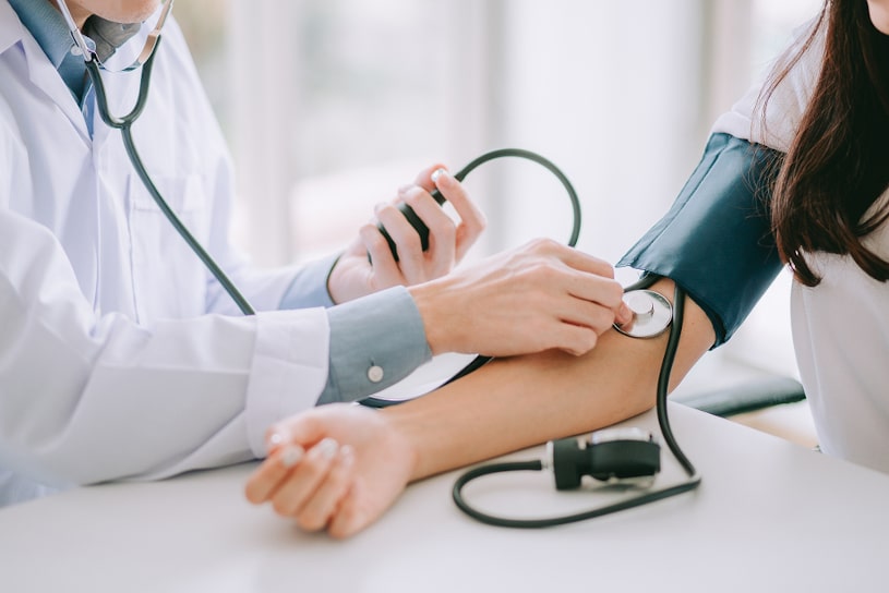 Doctor is checking blood pressure.