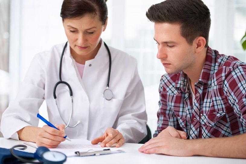 Female doctor and male patient discussing adderall withdrawal plan.