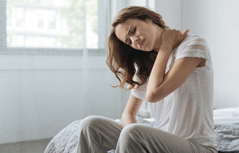 Woman touching her neck because of pain.