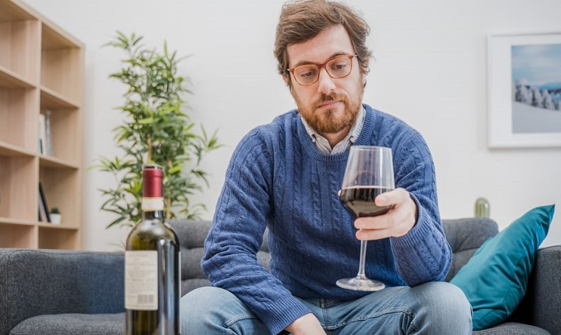 Depressed man with alcohol drink.