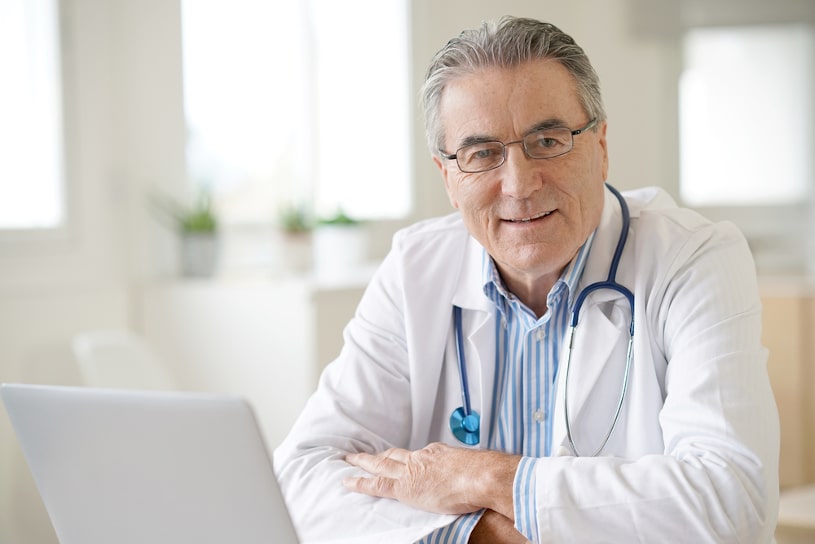 senior doctor sitting in his medical office.