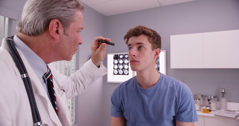 Mid-aged doctor examining alcoholic's cognitive functions.