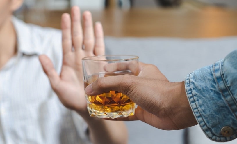 Person refuses to drink alcohol.