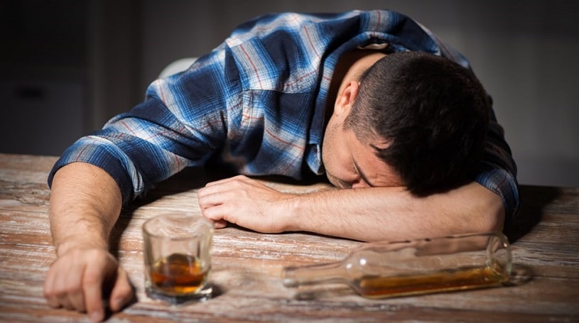 Man with a glass has drunk a lot of alcohol.