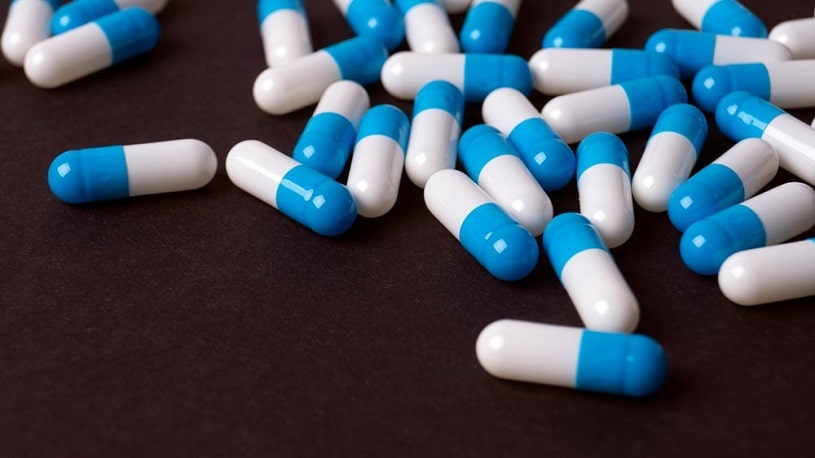 Cymbalta capsules on black background.