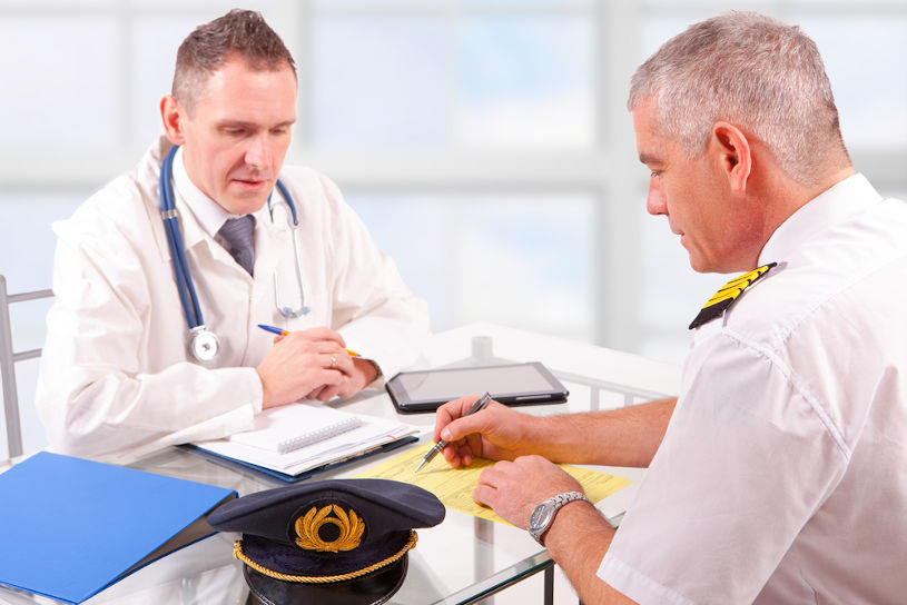 Airplane pilot during medical exam with doctor.